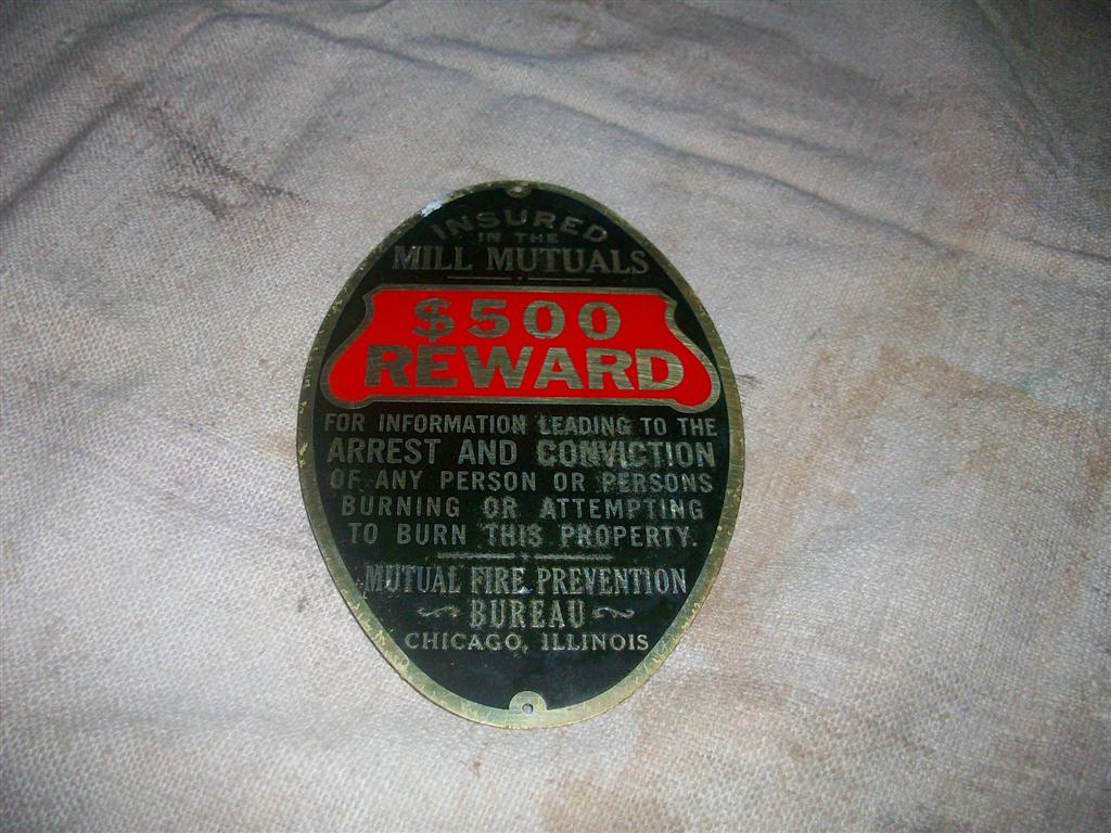 Oval aluminum sign offering a $500.00 reward for i