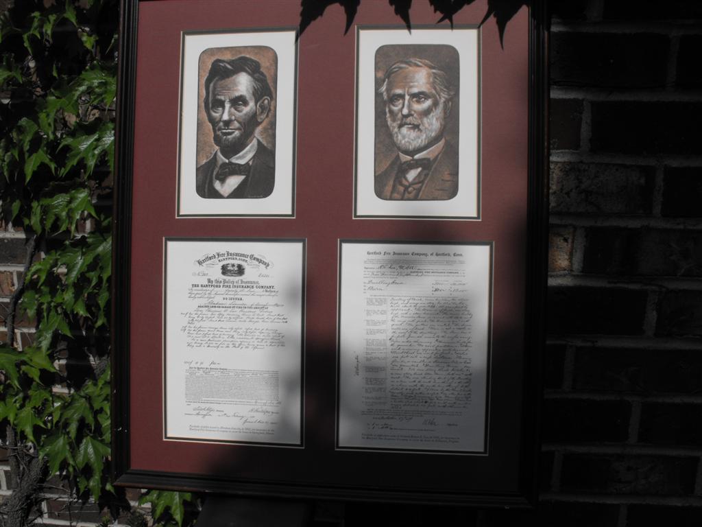 Reproductions of 2 Insurance Applications framed a