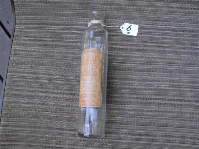 Pyrofite Fluid Fire Extinguisher glass container.