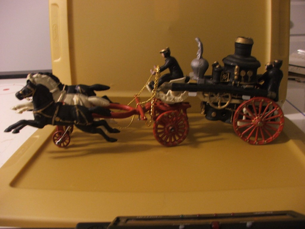 Cast Iron horse-drawn fire engine. 21" long by 8"