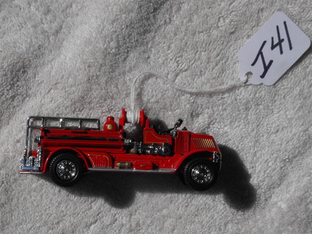 Toy Red Fire Truck. 4 1/4 inches long. 1 1/4 inc