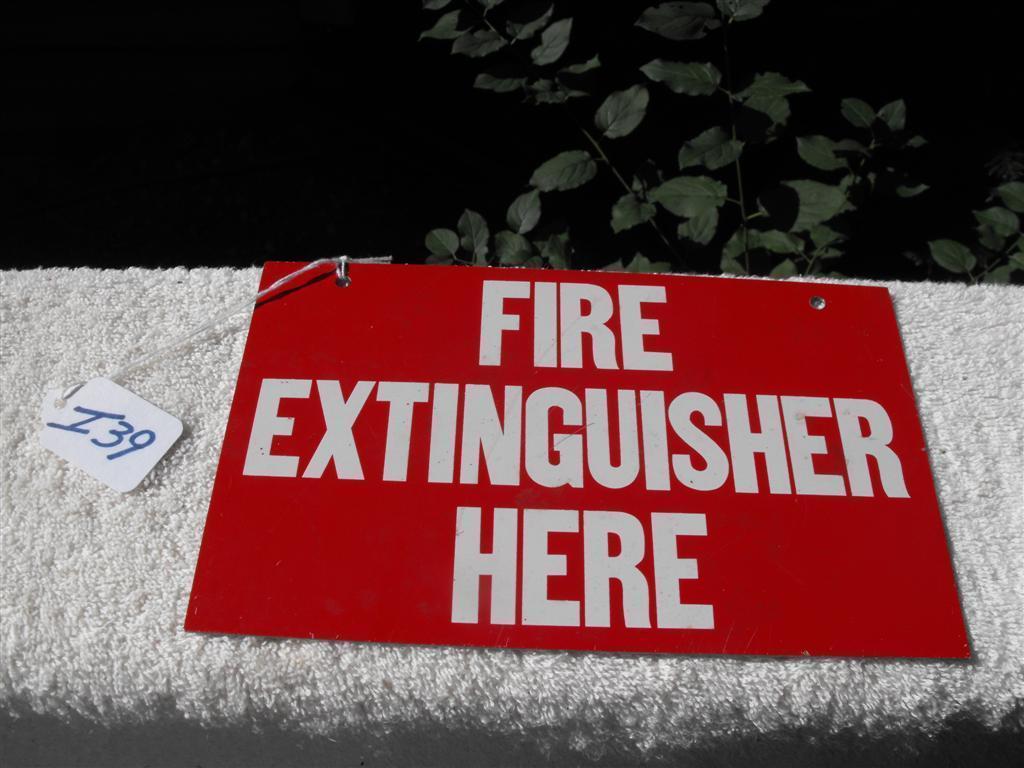 Fire Extinguisher Here Sign. Same thing written o