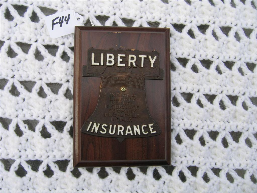 Liberty Insurance Auto Tag/Badge. Mounted on Wood