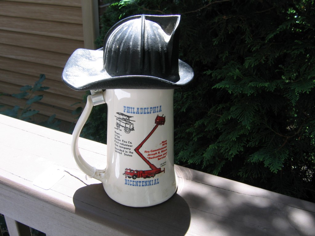 White Mug with Black Fire Helmet as Lid. Phila. F