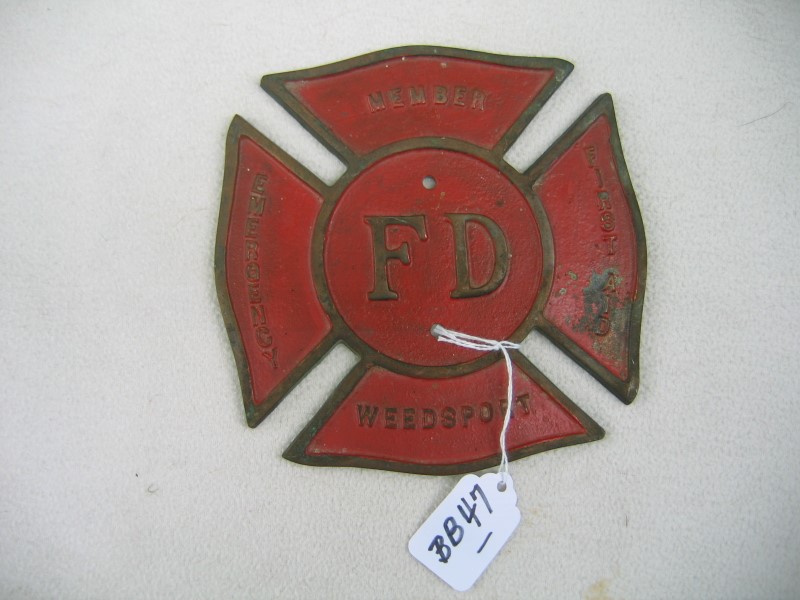 Metal Fire Department Item. Background is Red wit