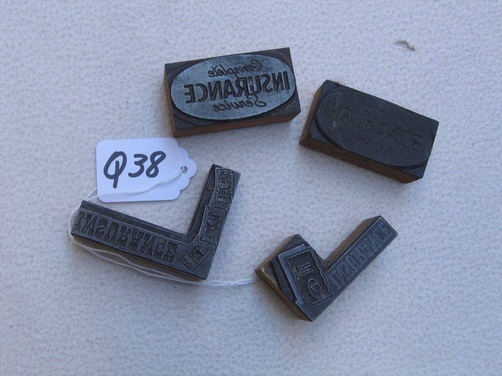 Four Wood Printer Blocks. 2 say "Insurance." 2 th