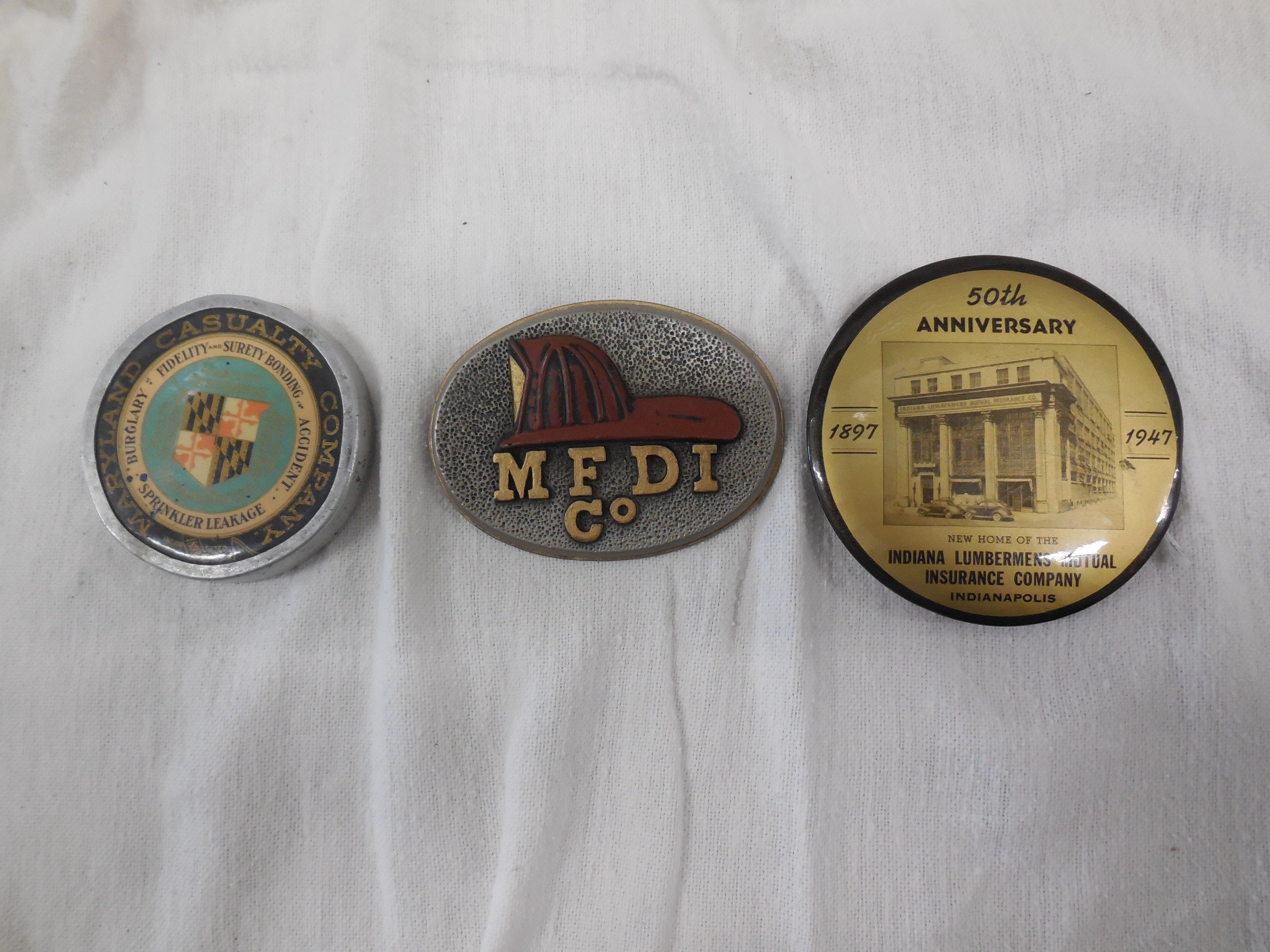 3 paperweights - Maryland Casualty, MFDI (Franklin Mint), and Lumberman's Mutual