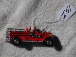 Toy Red Fire Truck. 4 1/4 inches long. 1 1/4 inc