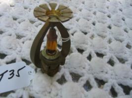 Sprinkler Head. Amber Liquid still in middle. Ma