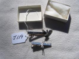 Two Different Tie Tacks. One is for Liberty Mutua