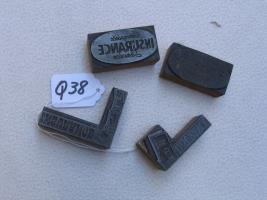 Four Wood Printer Blocks. 2 say "Insurance." 2 th